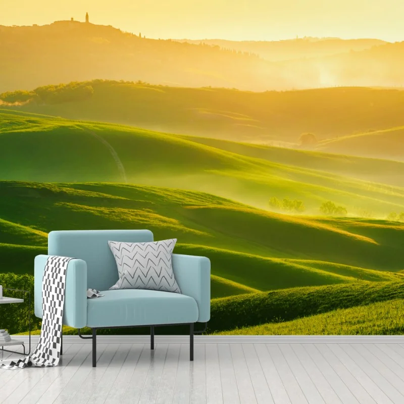 Fototapete goldener sonnenaufgang über sanften grünen hügeln
