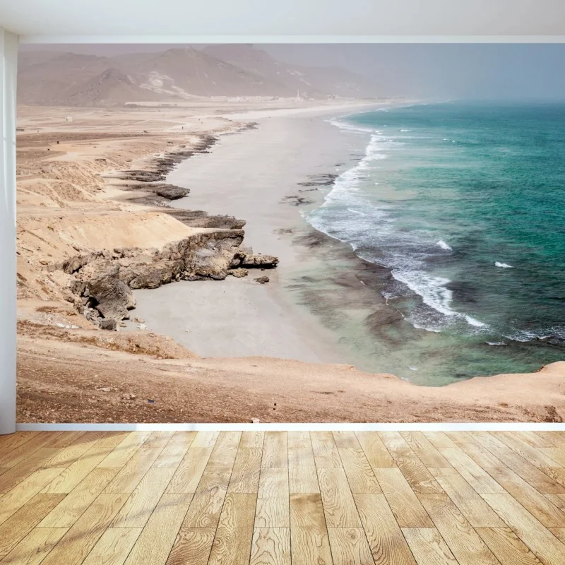 Fototapete ruhige türkisfarbene küstenlinie über wüstenklippen