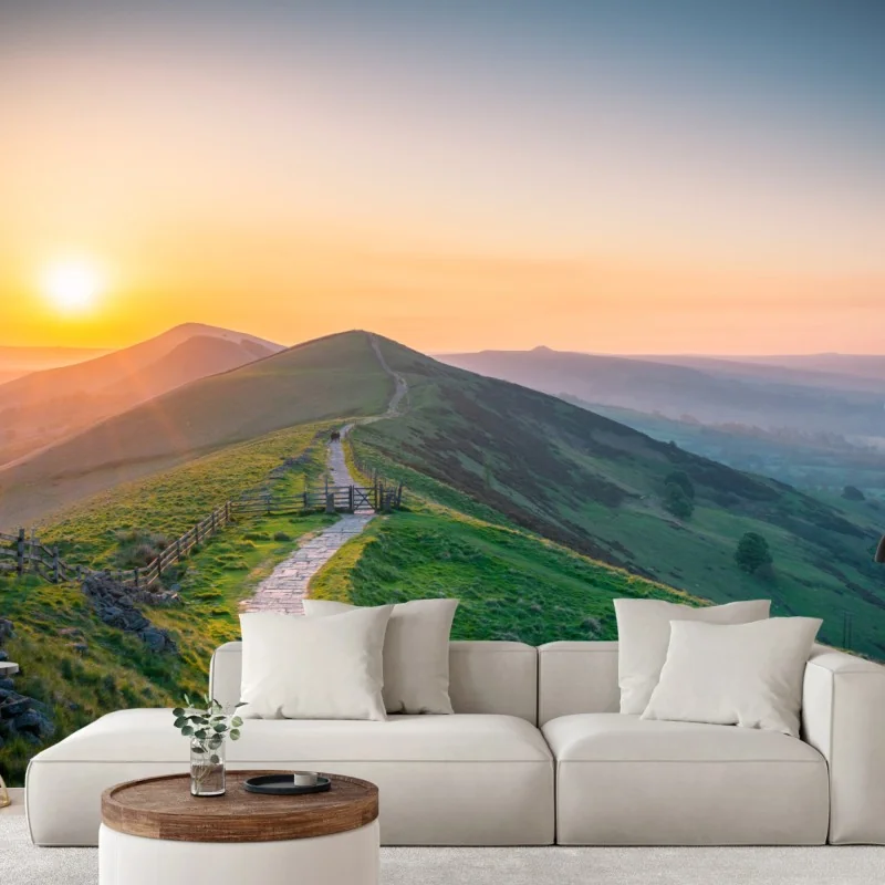 Fototapete sonnenaufgang über grünen hügeln mit steinweg