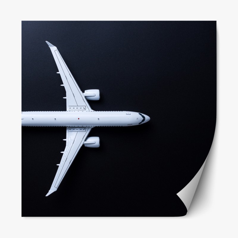 Repositionierbarer Aufkleber weißes flugzeug von oben auf schwarzem hintergrund