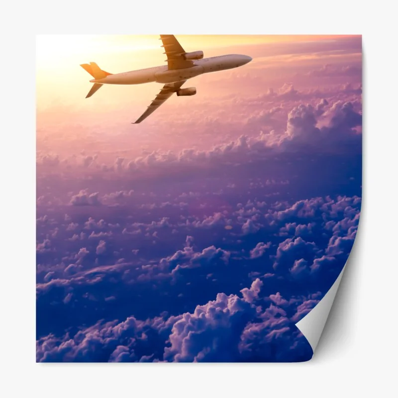 Repositionierbarer Aufkleber flugzeug über den wolken bei sonnenaufgang